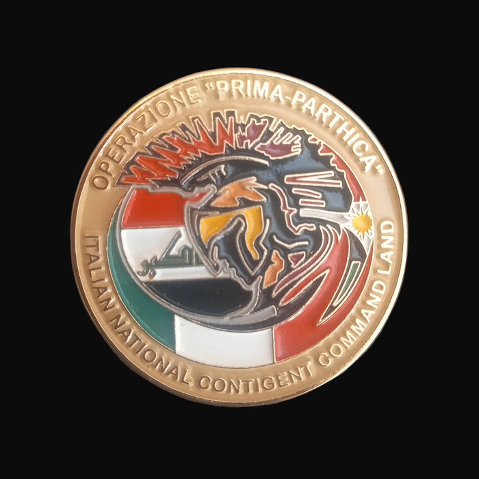 Decorative coin with Italian National Contingent Command Land emblem on a dark background