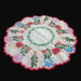 Decorative hungarian kalocsa coloful wreath doily with floral patterns on a black surface