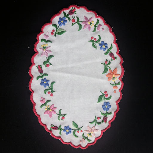 Hungarian kalosai Embroidered floral doily on a dark background