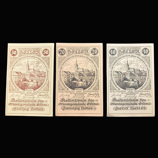 Three vintage notgeld heller banknotes with ship illustrations on a dark textured background
