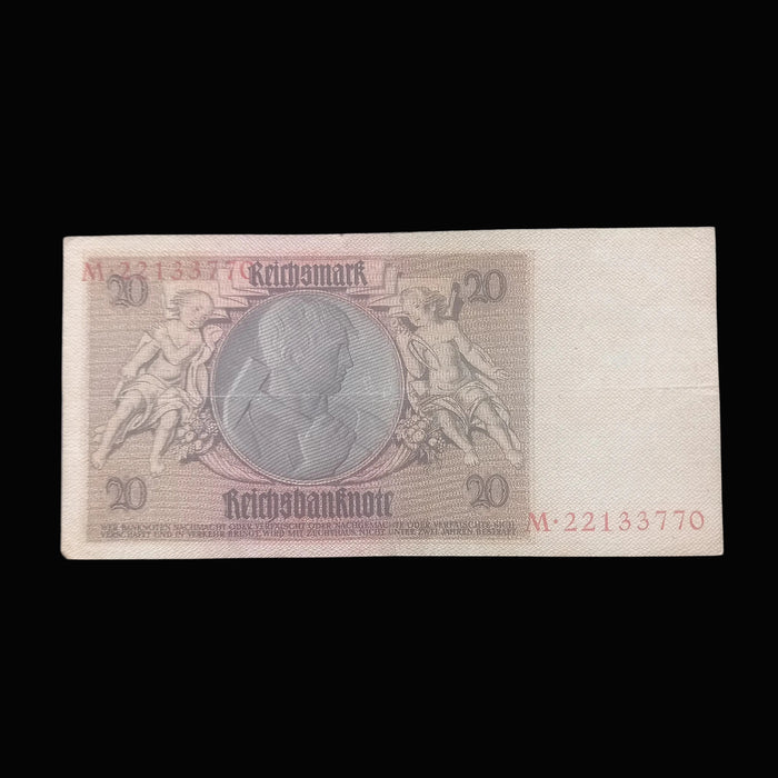 A vintage 20 Reichsmark banknote from Germany, displayed flat against a dark textured fabric background.
