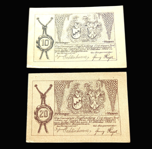Two vintage banknotes with decorative elements and text on a dark background