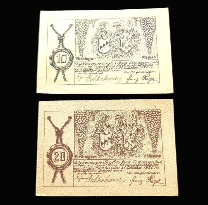 Two vintage banknotes with decorative elements and text on a dark background