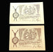 Two vintage banknotes with decorative elements and text on a dark background