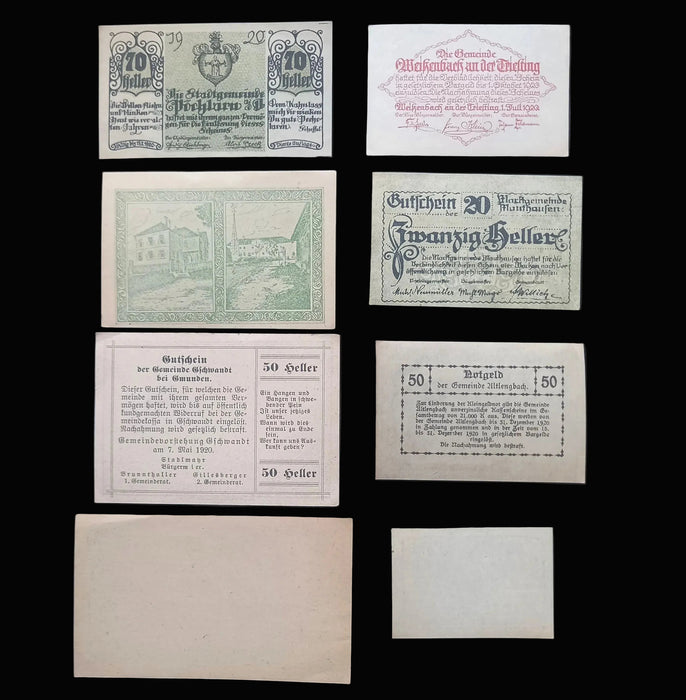 A set of vintage German banknotes and paper vouchers arranged on a dark background, including notes of 20, 30, 50, and 70 Heller with printed text and illustrations.