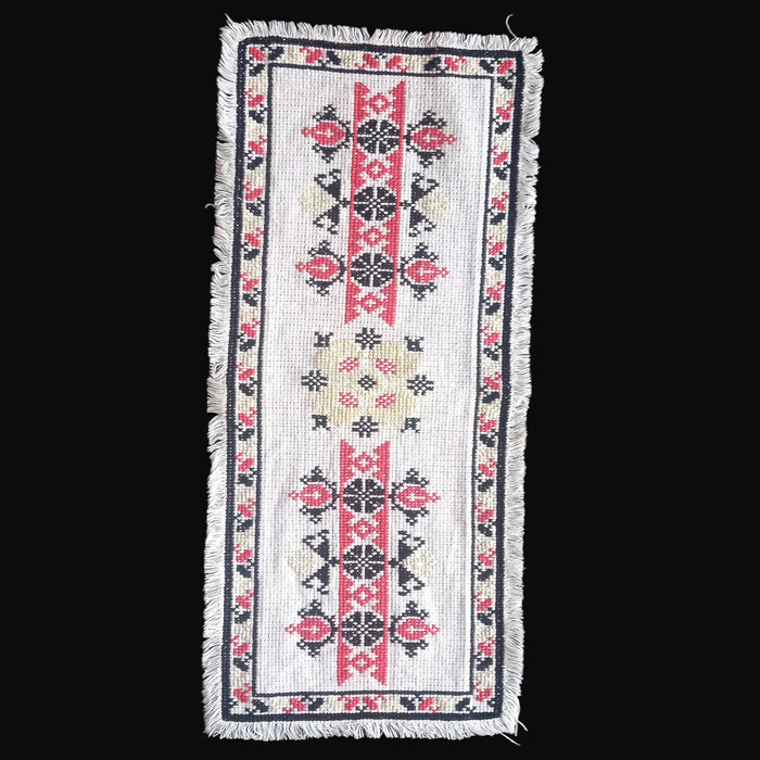 Mid-century Hungarian cross-stitched table runner with red and black geometry and fringed border