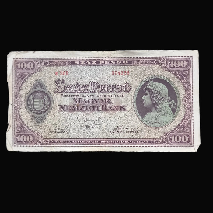A vintage 1945 Hungarian 100 Pengo banknote from the Magyar Nemzeti Bank, displayed flat against a dark textured background.