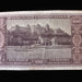 A vintage Hungarian 100 Pengó banknote featuring a sepia-toned illustration of the Buda Castle and Danube River, photographed flat against a dark background.