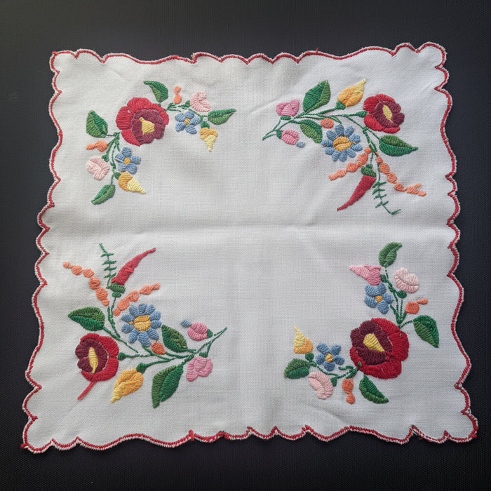 Vintage hungarian kalocsa table topper frorm 1970s on black surface