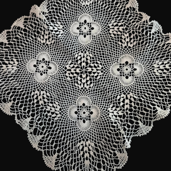Decorative Hungarian lace doily with intricate patterns on a dark background