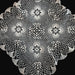 Decorative Hungarian lace doily with intricate patterns on a dark background