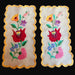 Two Hungarian Kalocsa embroidered floral designs on a beige linen with yellow scalloped edges.