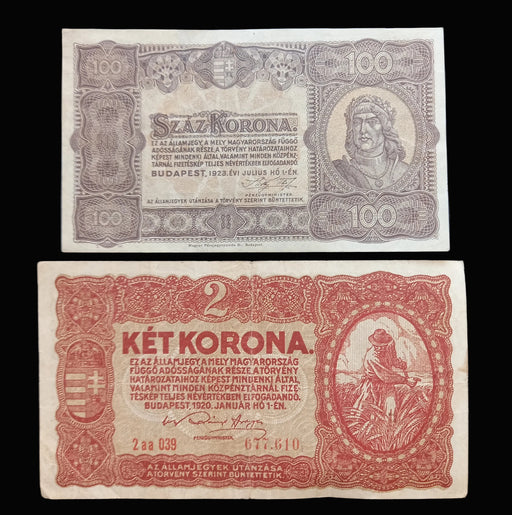 Two vintage Hungarian banknotes displayed on a dark background: a 100 Forint Százkoróna note above and a 2 Két Koróna note below.