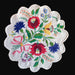 Embroidered table centerpiece hungarian kalocsai style with colorful floral design on a black background