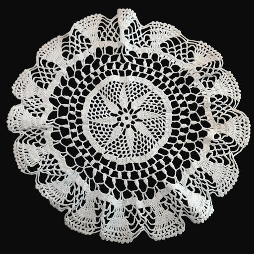 Hungarian lace Crocheted doily with intricate patterns on a dark background