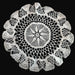 Hungarian lace Crocheted doily with intricate patterns on a dark background