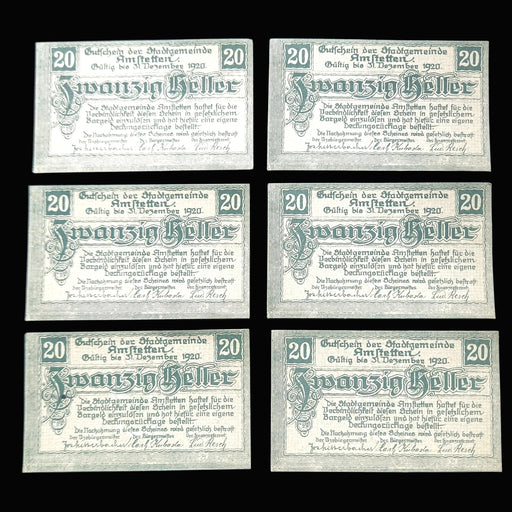 Six identical old German banknotes on a dark background
