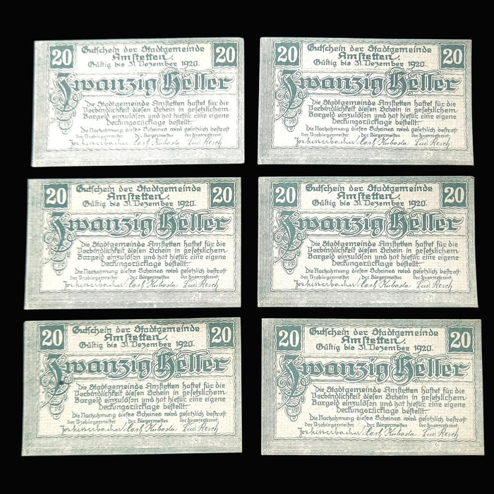 Six identical old German banknotes on a dark background