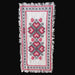 Embroidered Hungarian textile with heart pattern on a dark surface