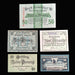 Collection of vintage German notgeld pfennig banknotes on a dark fabric background