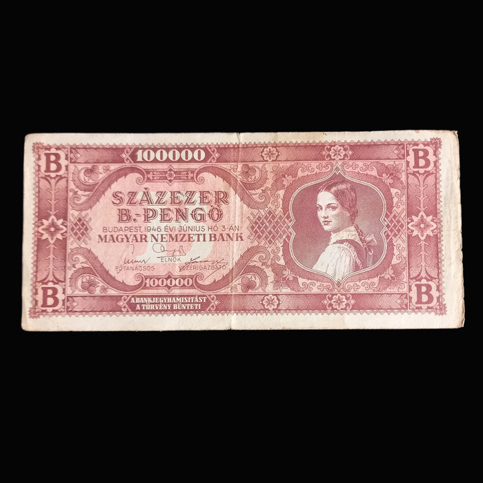 Vintage Hungarian 100 quadrillion szazezer b-pengo banknote with intricate design on a dark background