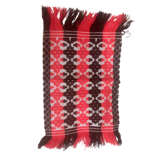hungarian vintage Woven textile with red, black, and white pattern on a white fabric background