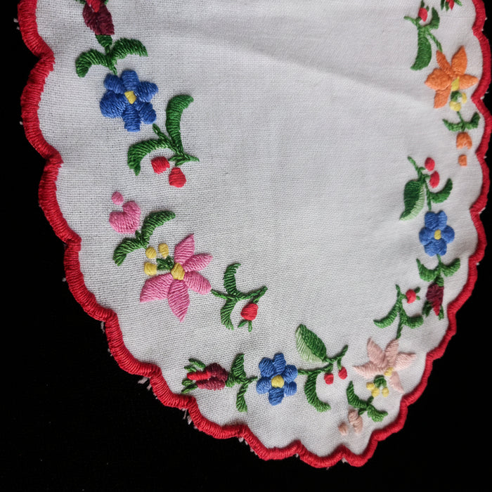 Embroidered floral design on a white fabric with a red border. Kalocsa Hungary, Europe