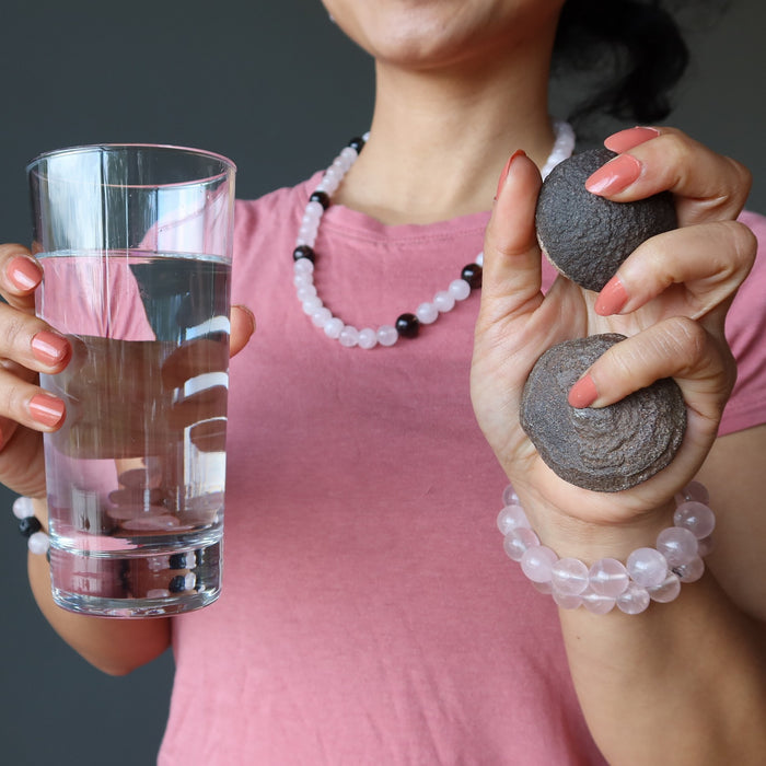 woman holding water and moqui marbles