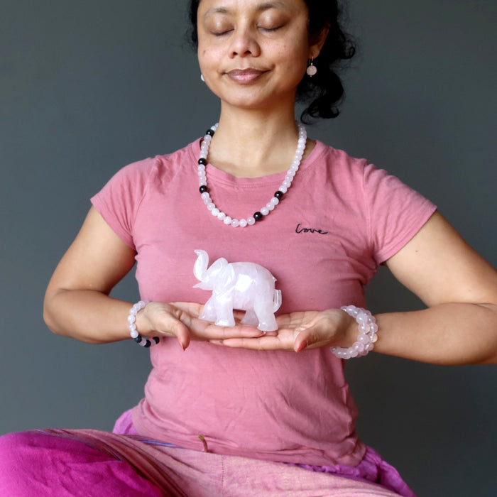 woman meditating with rose quartz crystals