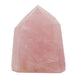 Pink rose quartz crystal tower on a white background