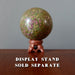 Decorative ruby fuchsite stone sphere on a stand with 'Display Stand Sold Separately' text.