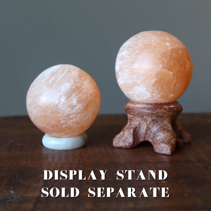 orange selenite spheres on stands