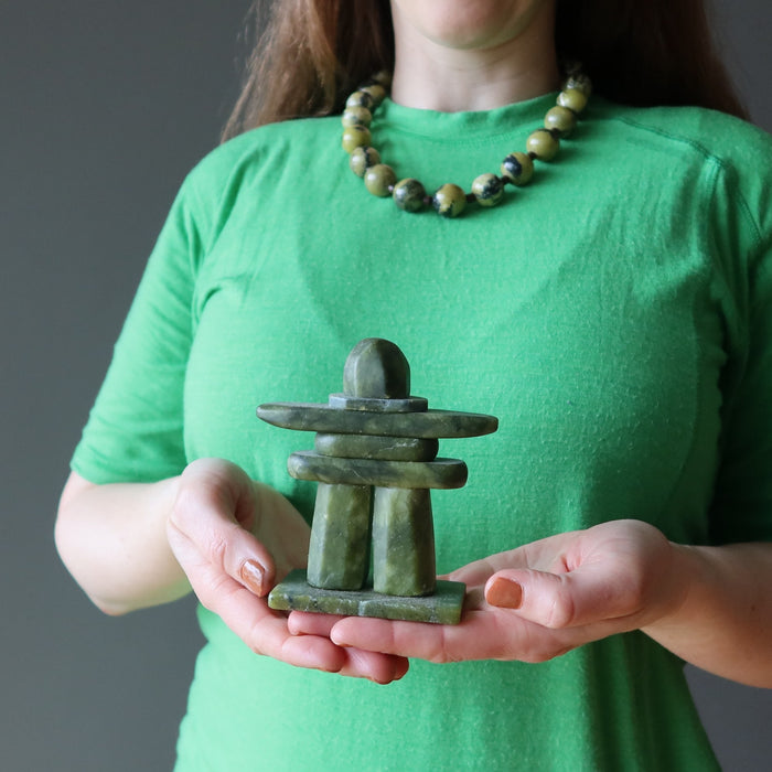 hand wearing and holding serpentine stones