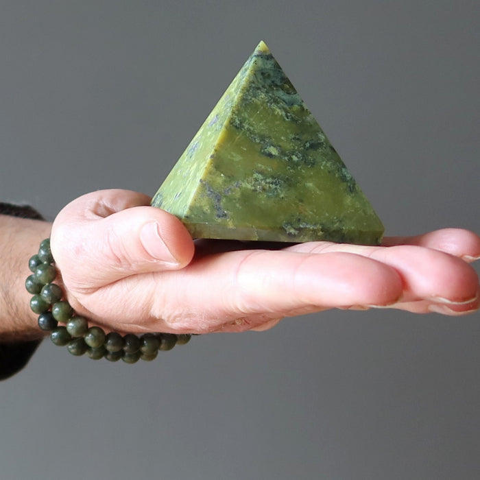 hand wearing and holding serpentine stones
