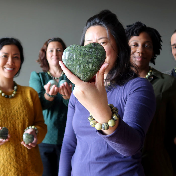 people wearing and holding serpentine stones