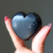 Shungite Heart-shaped black stone held in a hand