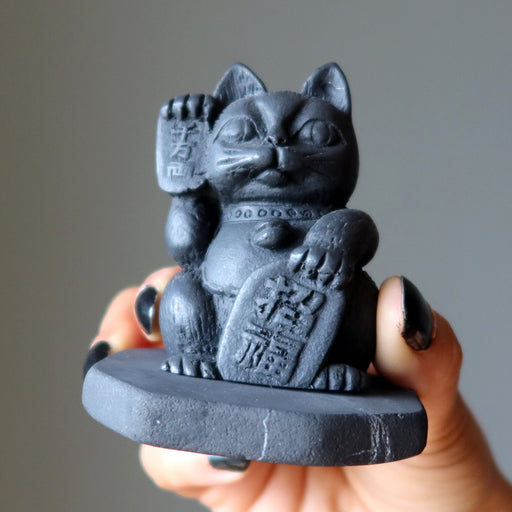 Black cat figurine with a Shungite base