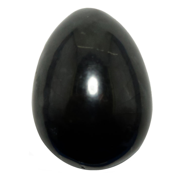 Black shungite stone egg on a white background