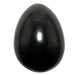 Black shungite stone egg on a white background