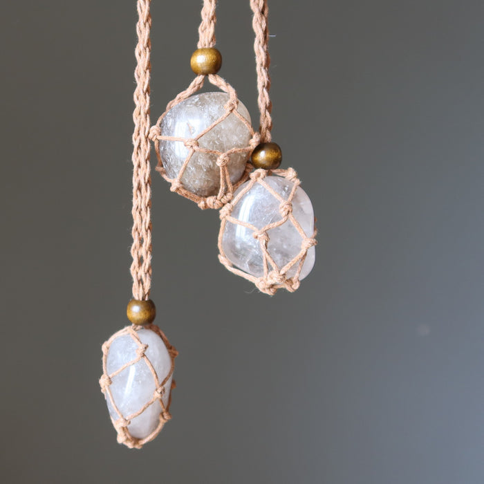 3 necklaces with smoky quartz stones and braided cord on a gray background