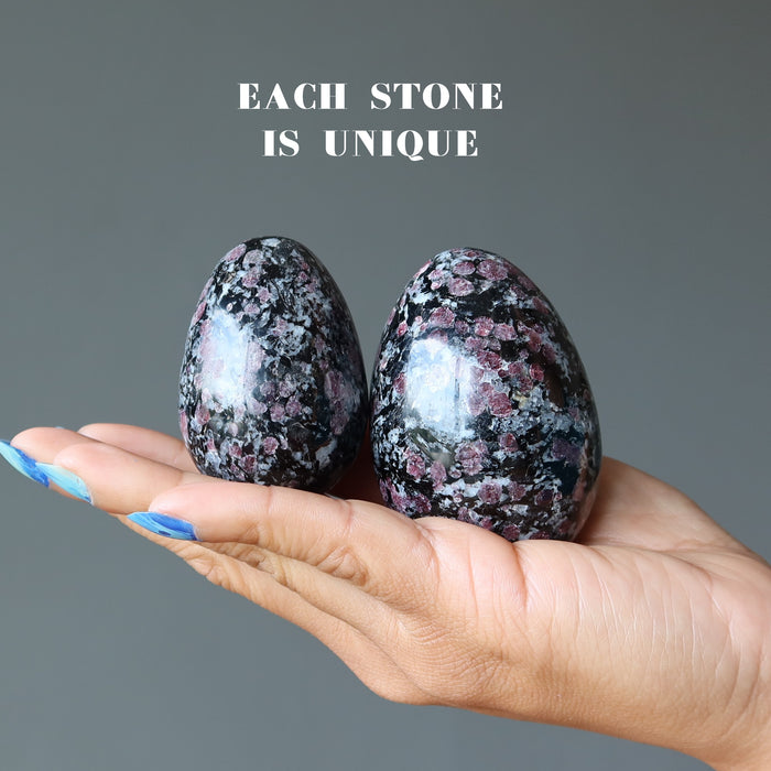 two spinel eggs in hand