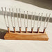 Set of tuning forks on a wooden stand on a light wooden surface