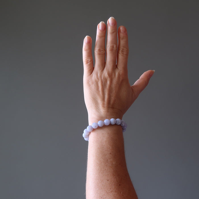 hand wearing blue lace agate round beaded stretch bracelet