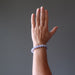 hand wearing blue lace agate round beaded stretch bracelet