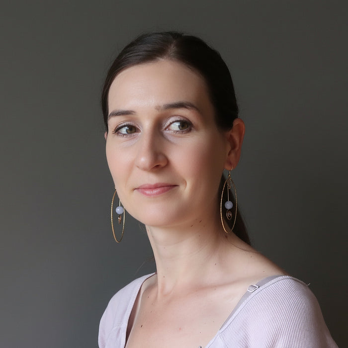 woman wearing blue lace agate gold hoop earrings