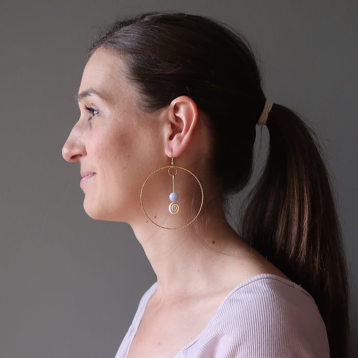 woman wearing blue lace agate gold hoop earrings