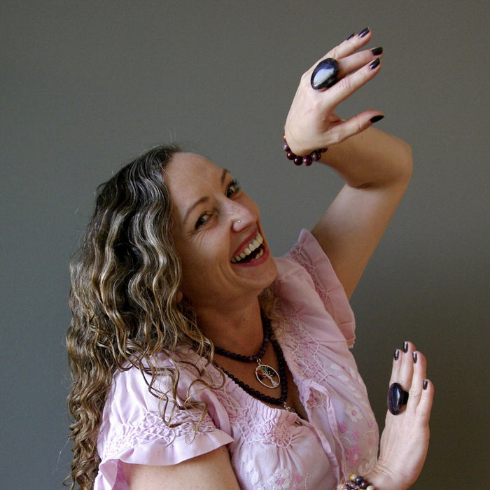 woman wearing purple dendritic agate rings