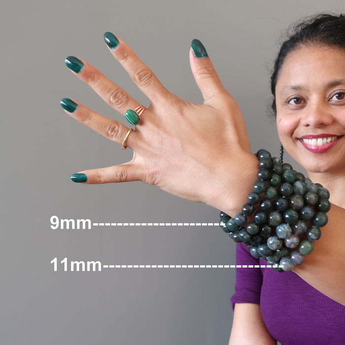 sheila of satin crystals wearing a stack of green and white moss agate round beaded stretch bracelets to show 9mm and 11mm bead sizes
