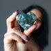 woman holding moss agate heart