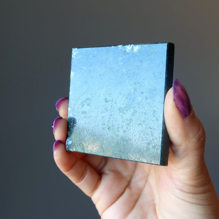 showing the bottom of a green and white moss agate pyramid